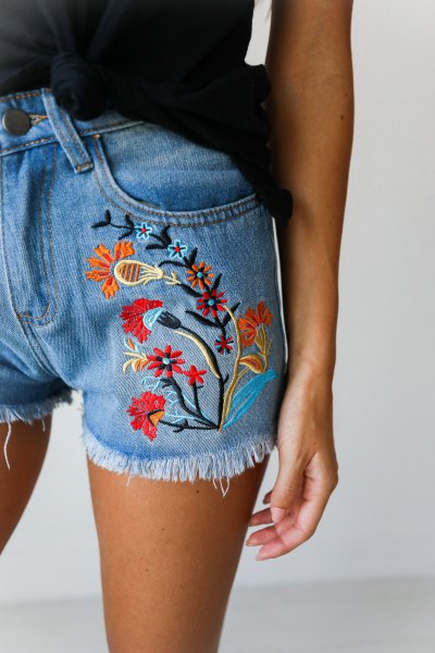 Black tank top with blue denim shorts embroidered with flowers