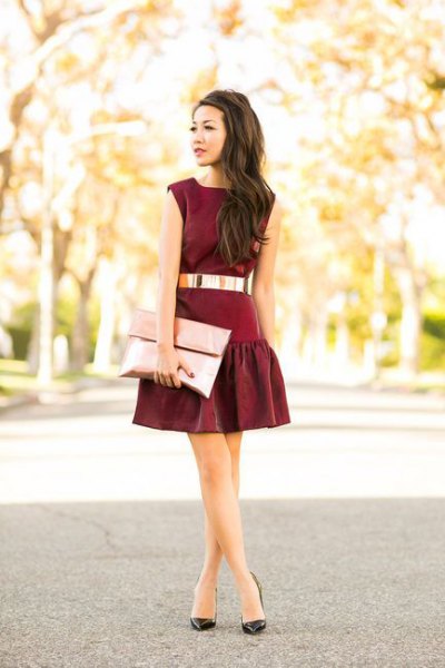 Black belted mini skater dress with rose gold metallic clutch