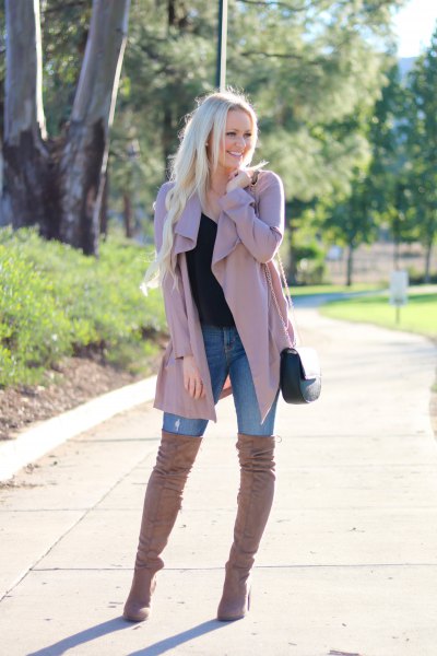 pink trench coat with blue skinny jeans and thigh high boots