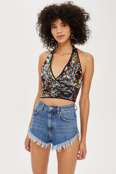 Silver and black patterned metallic halter top with high-rise blue denim shorts