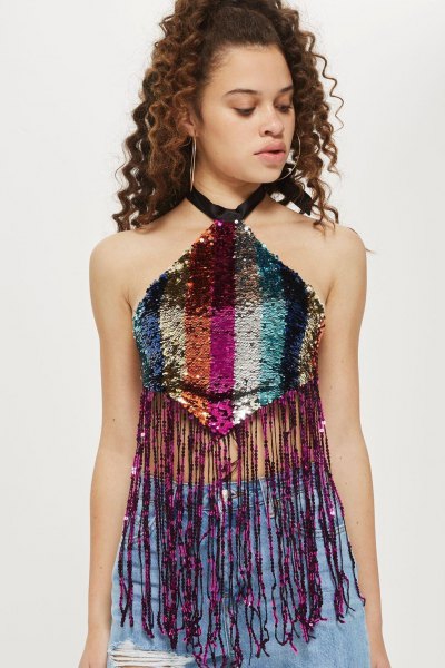 Multicolor halter crop top with sequin fringe and blue ripped jeans