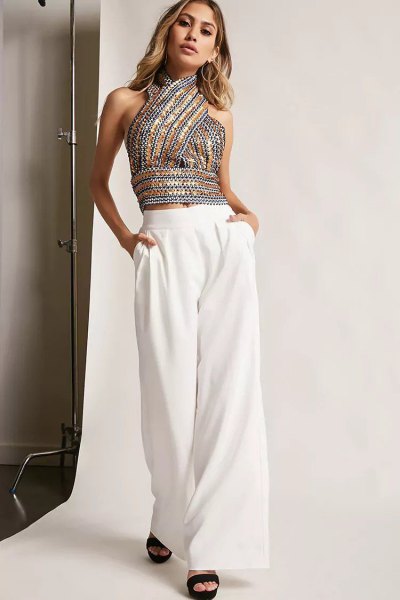 Silver and gold patterned sequin halter top and white wide leg trousers