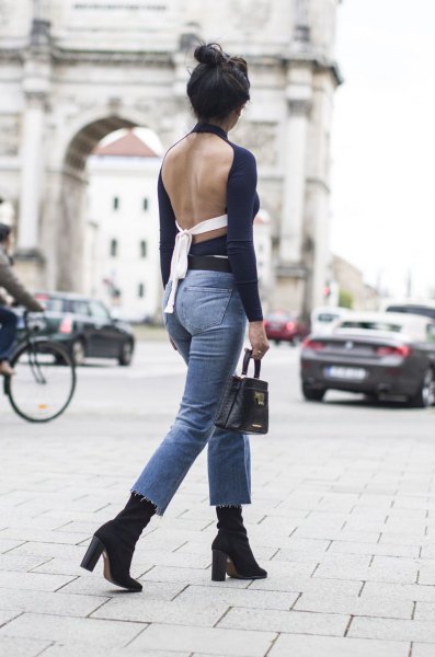 Black long sleeve backless top with blue slim fit ankle jeans