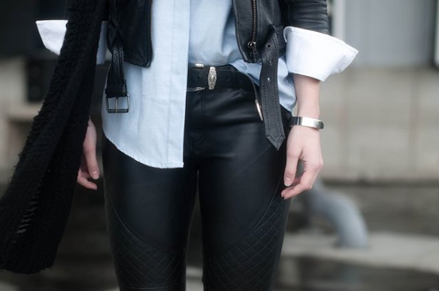 Black leather jacket with white button down shirt and belted biker
pants