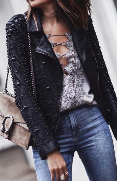 Leather jacket with black studs and blue jeans