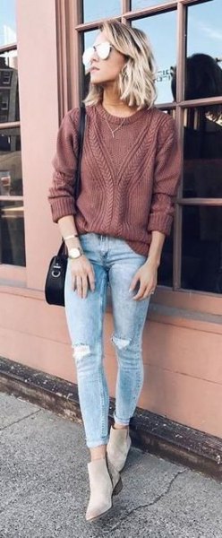 Green ribbed sweater with blue ripped cuffed jeans