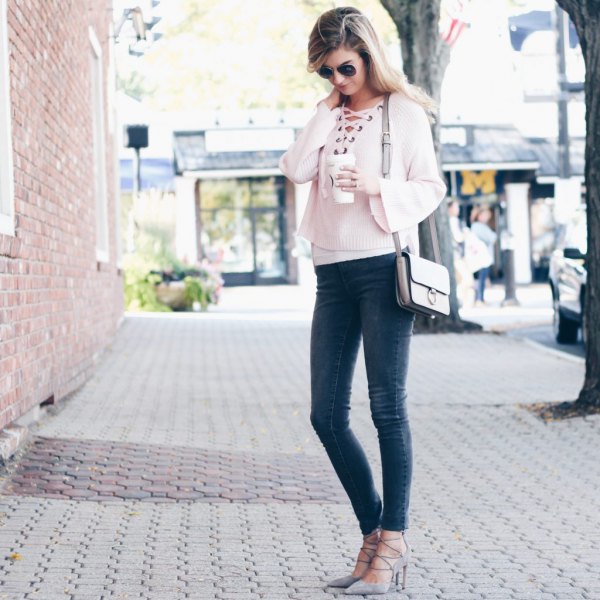 White cropped lace-up sweater with gray skinny jeans