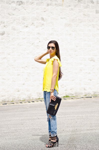 Yellow sleeveless blouse with ruffled shoulders and cuffed boyfriend jeans