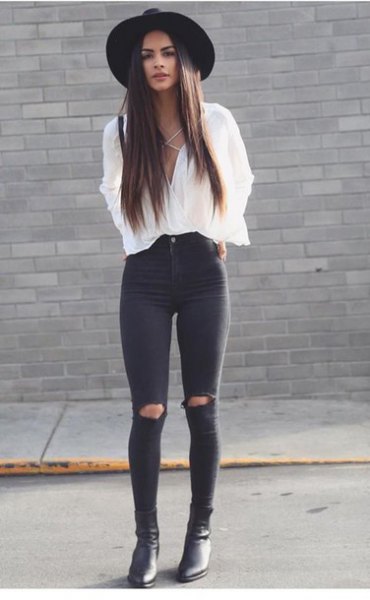 White V-neck lace-up blouse paired with black knee-ripped skinny jeans