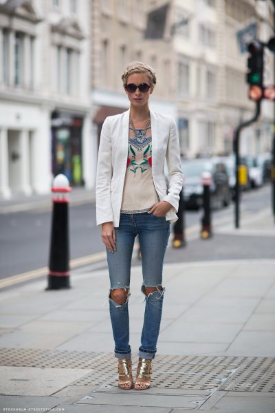 White blazer with pink graphic tee and ripped jeans