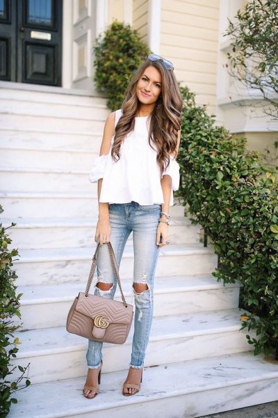 White chiffon blouse with cold shoulders and ripped slim fit jeans