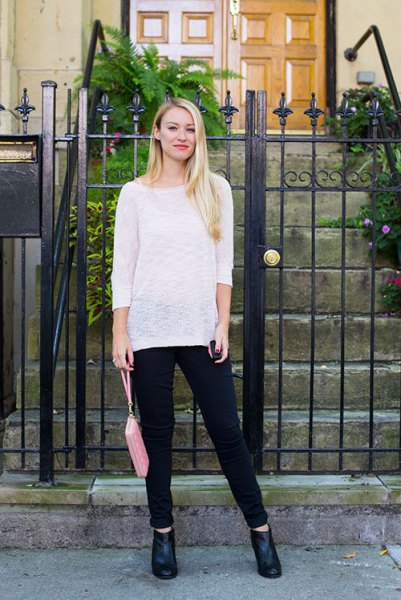 White semi sheer casual boat neck sweater paired with black jeans
