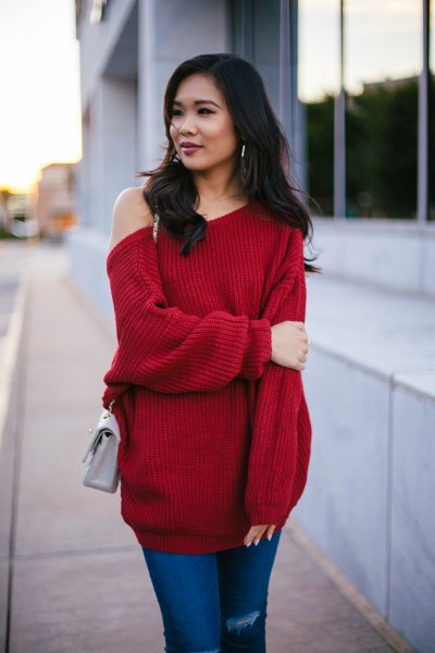 Red thick tunic sweater with blue jeans