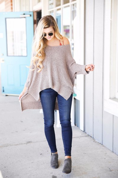 Gray strapless slouchy sweater with dark blue skinny jeans