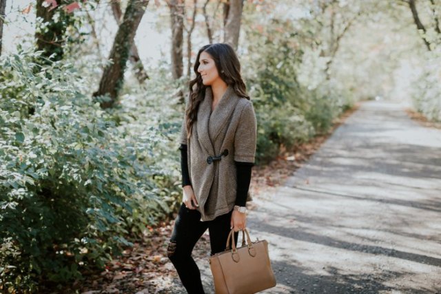 Gray sweater with half sleeves, black long sleeve shirt and brown leather bag