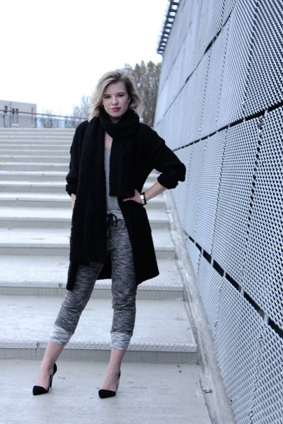 black long wool coat with mottled grey, shortened knit
trousers