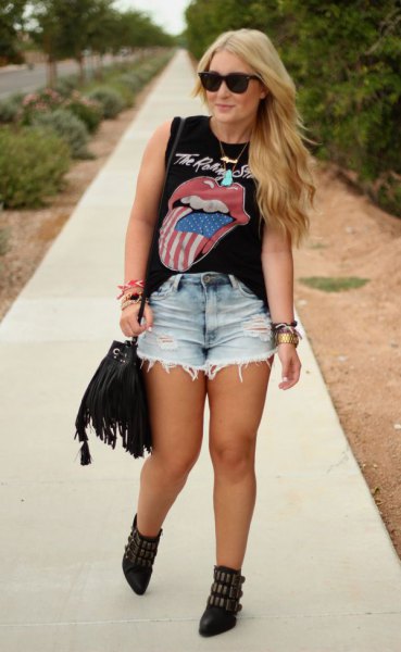 distressed black graphic sleeveless top with light blue high waisted denim shorts