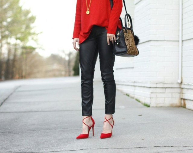 Red sweater with black leather trousers and strappy sandals