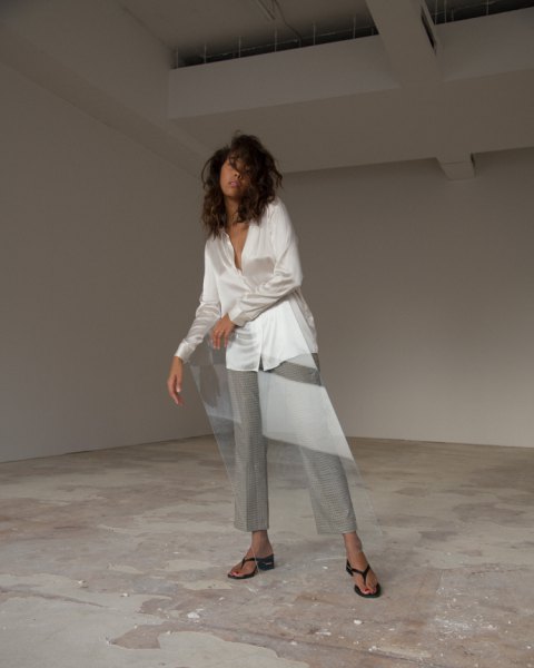 white oversized silk blouse with gray wide leg chinos and black flip flop heels