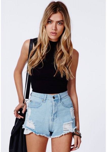 Black sleeveless high neck bodycon top paired with light blue denim mini shorts