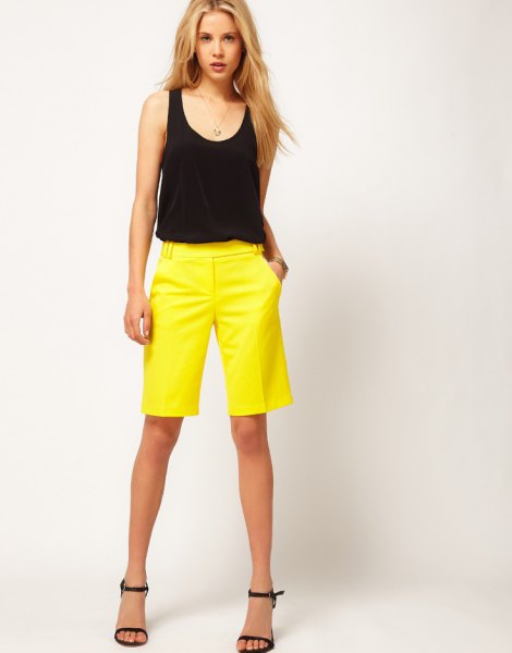 Black sleeveless scoop neck tank top and yellow suit shorts