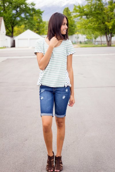 White and light gray striped t-shirt with blue cuffed long jean shorts