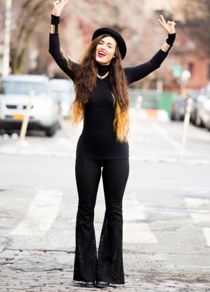 Black, form-fitting sweater with matching flared jeans