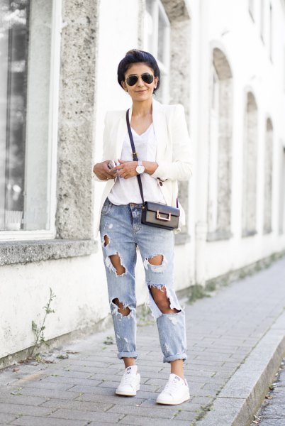 White blazer with v-neck t-shirt and badly ripped jeans