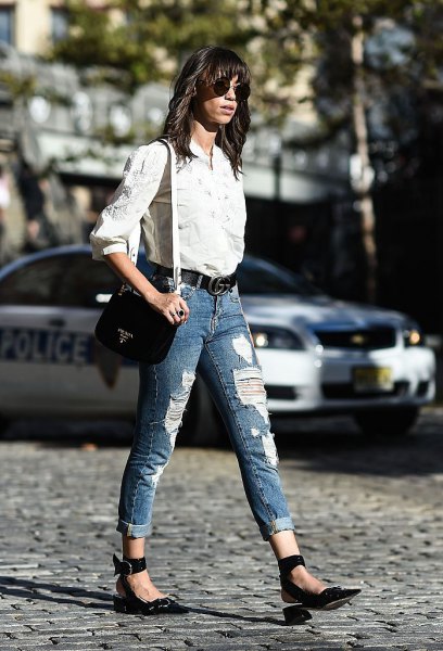 White button down shirt and blue ripped cuffed jeans