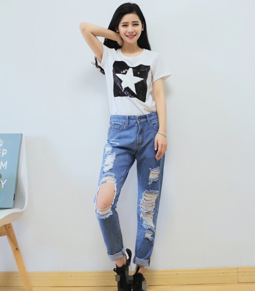 White graphic tee with light blue ripped boyfriend jeans