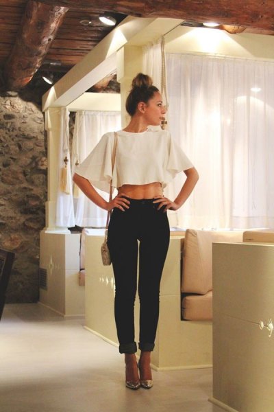White cropped batwing sleeve crop top and black cuffed slim fit jeans