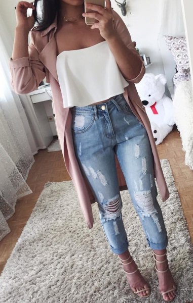White strapless blouse with gray longline trench coat and ripped jeans