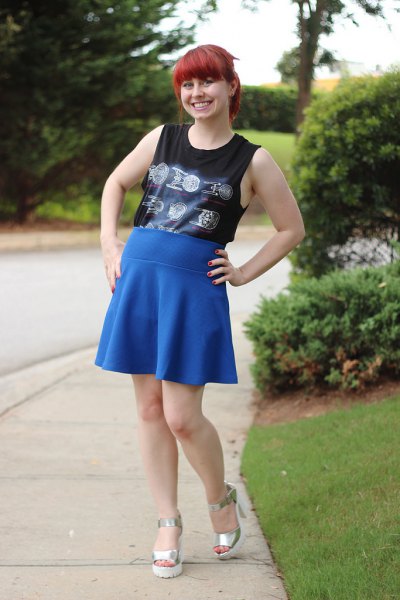 Black tucked-in tank top with royal blue high-rise skater
skirt