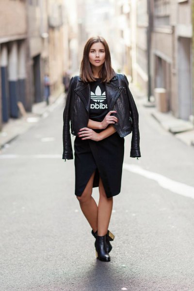 black leather jacket with graphic tee and knee length skirt