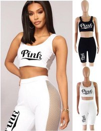 White graphic cropped tank top paired with knee length fitted
shorts