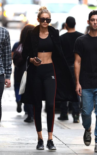 Black bomber jacket with a crop top and sports leggings