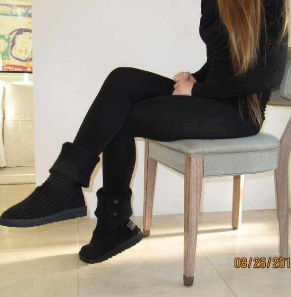 Black form-fitting sweater with matching mid-height boots