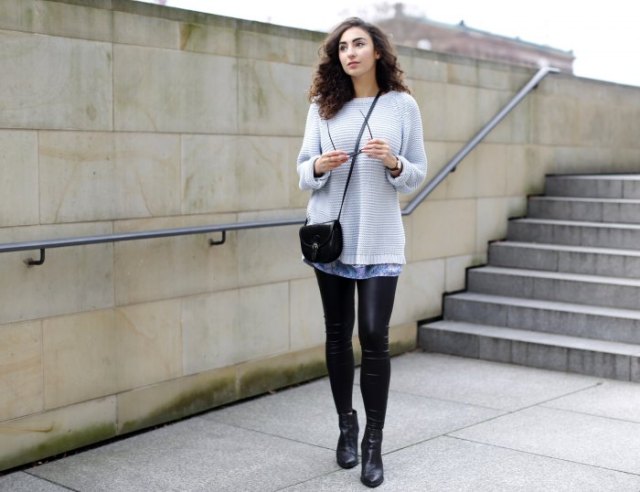 Light gray sweater over tie-dye tunic top and leather leggings