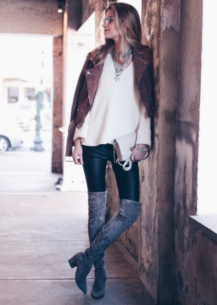 Black biker jacket with white V-neck sweater and leather winter leggings