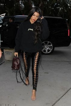 Black hoodie with leather lace-up leggings and bare heels