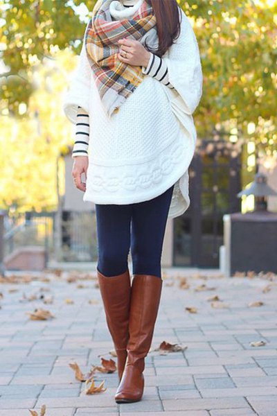 White loose tunic sweater with half sleeves and brown knee high
leather boots
