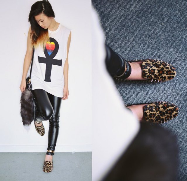 White sleeveless graphic t-shirt styled with black leather leggings
and leopard print spiked loafers
