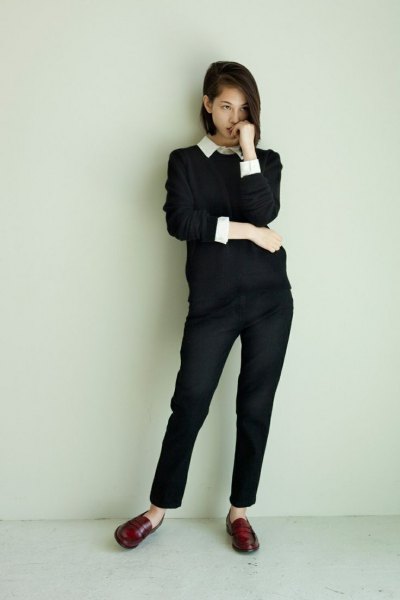 Black sweater with ankle length chinos and penny shoes