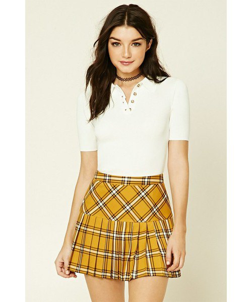 Mustard yellow checked pleated mini skirt with a white fitted polo shirt