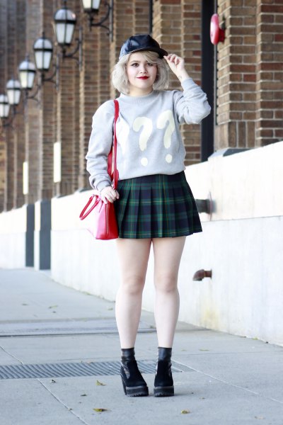 gray graphic sweater with navy blue plaid pleated mini skirt