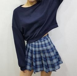 Black cropped boat neck sweater and plaid blue mini skirt