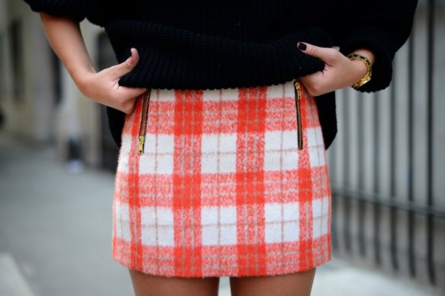 Red and white checked wool mini skirt with a black chunky knit
sweater