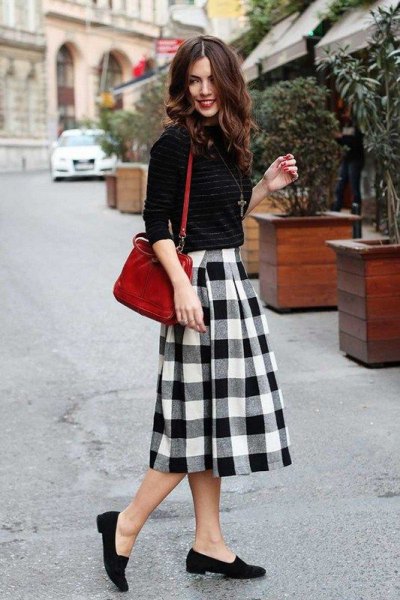 Tight-fitting knit sweater with a black and white checked midi wool skirt