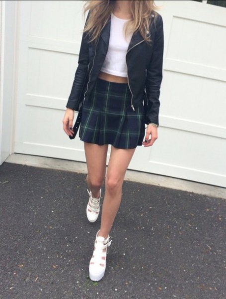 Black leather jacket with white cropped t-shirt and mini
skirt