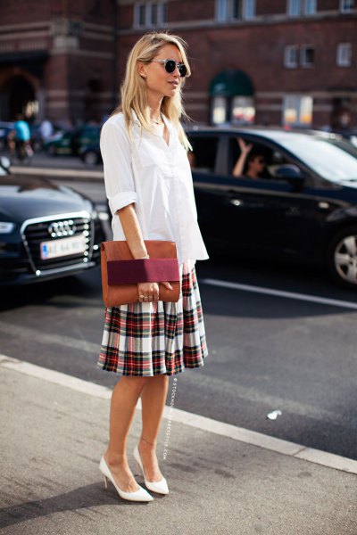 White blouse with buttons and loose-fitting plaid skirt